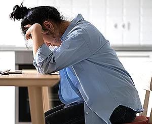 Person experiencing burnout, feeling mentally, emotionally, and physically exhausted at work.