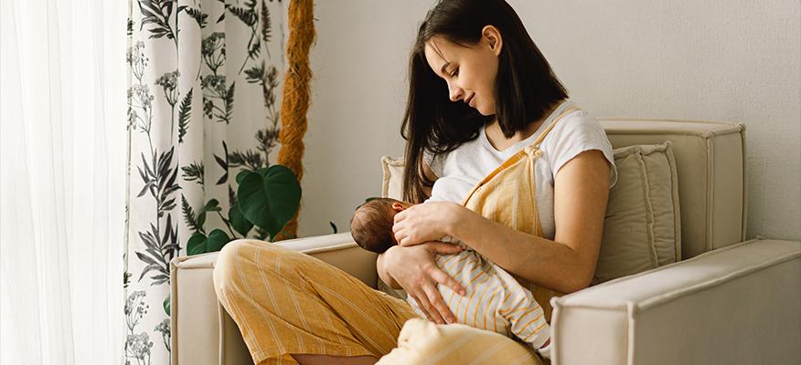 Mother breastfeeding her baby, highlighting the importance of nutrition and health for both.