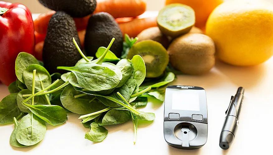 Fresh vegetables and fruits with a glucometer and insulin pen
