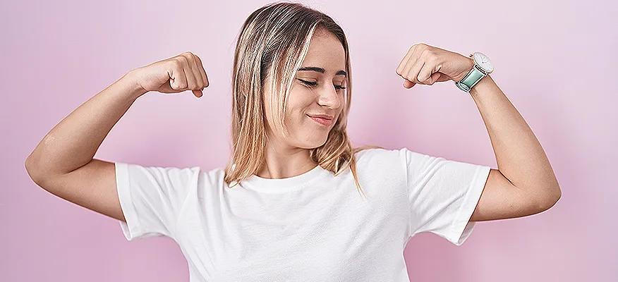 Female looking at her upper arm fat deposit