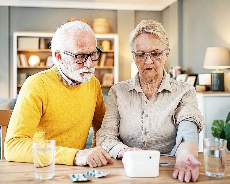 Senior man monitoring his blood pressure to maintain healthy aging