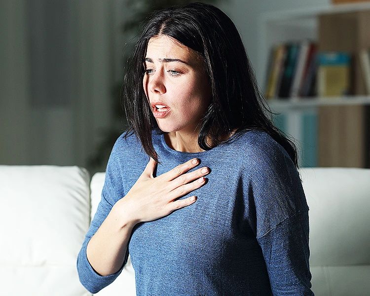 Woman experiencing anxiety disorder symptoms chest pain panic attack