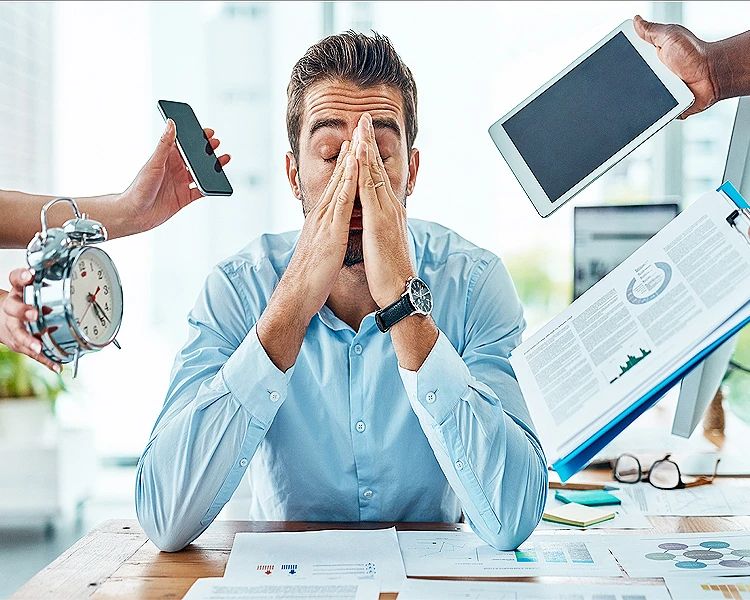 Work stress concept with overwhelmed office worker facing deadlines and digital distractions