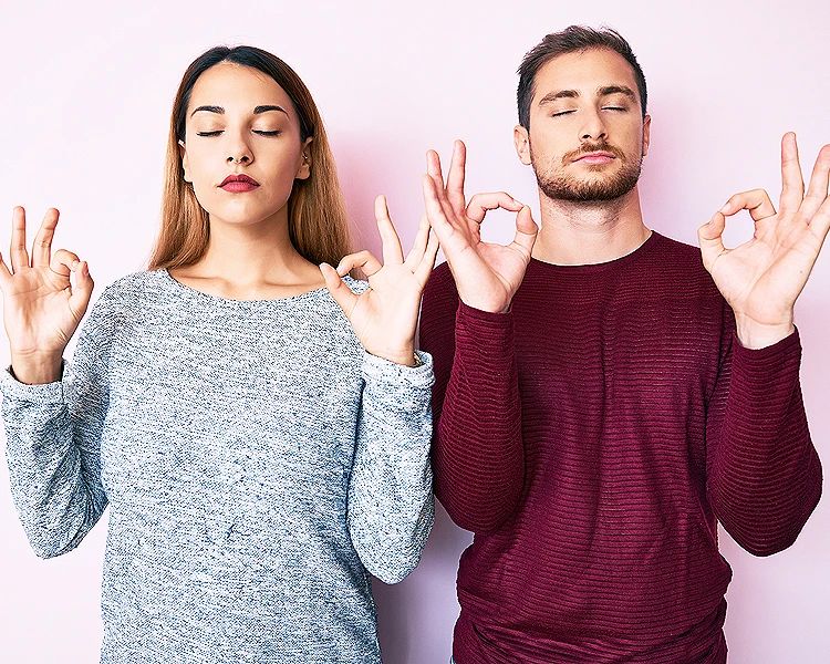 Man and woman practicing mindfulness meditation to reduce stress and anxiety